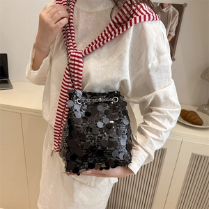 Sparkly black sequin bucket bag for women with silver chain strap and shiny round disc design