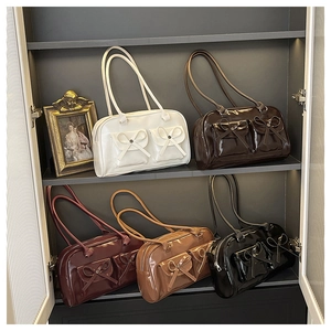 French luxury Boston bags in five colors featuring glossy finish and bow tie detail