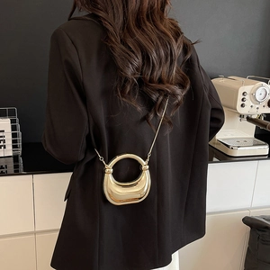 Chic metallic gold crescent moon crossbody bag with round handle and gold chain strap
