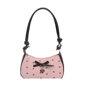 Pink and black underarm bag featuring bow patterns and 3D bow with heart charm