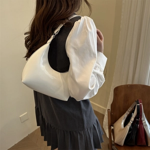 Minimalist white patent leather hobo bag with glossy finish and half-moon shape design