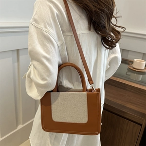 Chic retro patchwork shoulder bag in brown leather and cream canvas for women