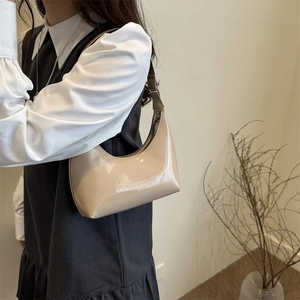Chic beige patent leather half-moon shoulder bag with sleek mirror finish for women