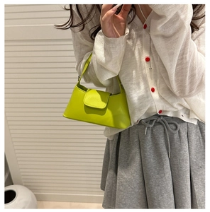 Fashionable bright green mini handbag with ABETIKA embossed flap shown on model