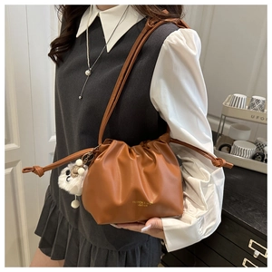 Caramel drawstring bag with gold lettering and cute white sheep charm pendant accessory
