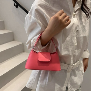 Minimalist pink leather handbag for women featuring flap closure and top handle design