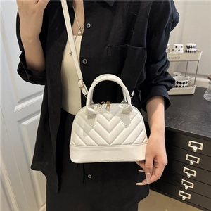 White quilted shell bag for women with V-shaped stitching and adjustable strap