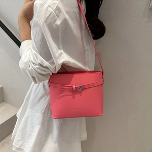 Vibrant pink leather bucket bag with silver buckle and thin shoulder strap for women