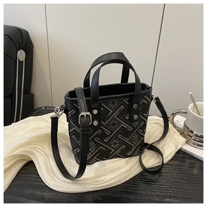 Detail of mini tote bag with geometric jacquard pattern and black leather handles