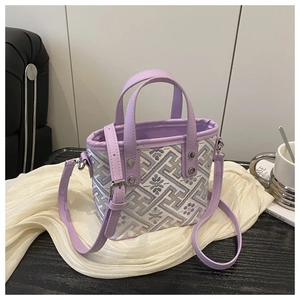 Detail of purple crossbody bag with geometric woven pattern and silver metal hardware