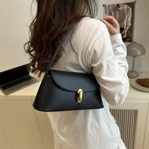 Minimalist black matte leather square shoulder bag with oval gold metal buckle and strap