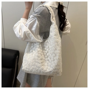 Detailed close-up of white floral lace tote bag with 3D daisy crochet texture for women