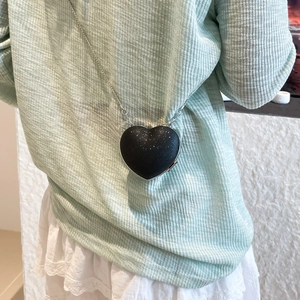 Chic black heart-shaped crossbody bag with glitter finish and silver chain strap