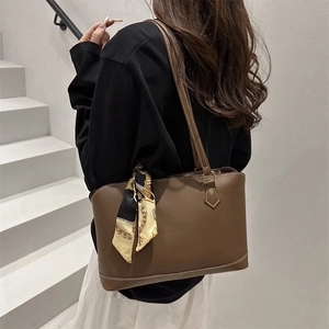 Minimalist brown faux leather tote bag with contrast stitching and decorative scarf