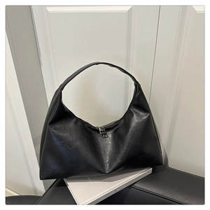 Macro detail of high-quality black faux leather texture and metallic zipper on tote bag