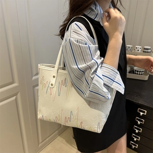 White leather tote bag with colorful wavy embroidery and gold hardware for daily use