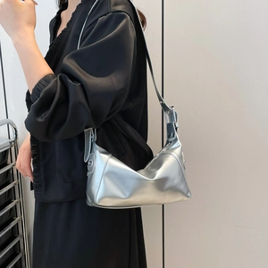 Minimalist silver metallic hobo shoulder bag with glossy mirror finish and adjustable strap
