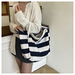 Close-up of navy and cream striped knit tote bag showing spacious square design