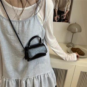 Glossy black patent leather mini crossbody bag with curved flap for women in summer