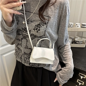 Minimalist white faux leather mini crossbody bag with flap closure and slim strap