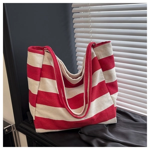 Detail view of large canvas tote bag with thick red and white horizontal stripes texture