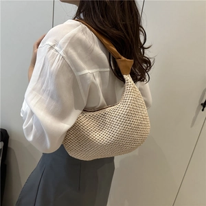 Fashionable beige woven straw underarm bag with brown leather strap for summer beach vacation