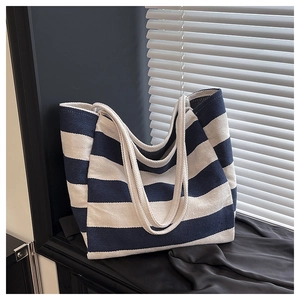 Detailed texture of navy blue and white striped canvas tote bag with sturdy handles