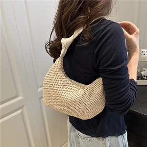 Stylish beige straw underarm bag with white knotted strap for summer beach vacation