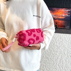 Chic fuchsia leopard print plush handbag with soft faux fur and circular zipper handle