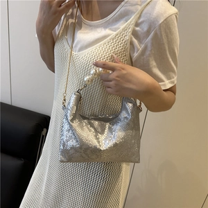 Silver snakeskin crossbody bag with large pearl handle and elegant gold chain strap