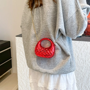Bright red acrylic shell moon bag with quilted weave texture and golden chain strap