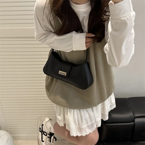 Minimalist black crescent moon baguette bag with a chic gold buckle for women