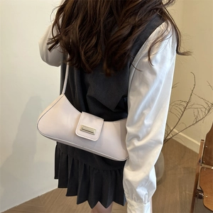 Minimalist cream baguette shoulder bag for women with vintage metal buckle detail