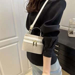 Fashionable cream color block box bag with adjustable leather strap and golden zippers