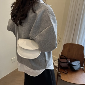 Minimalist semi-circle saddle bag for women shown in white, brown, and black options