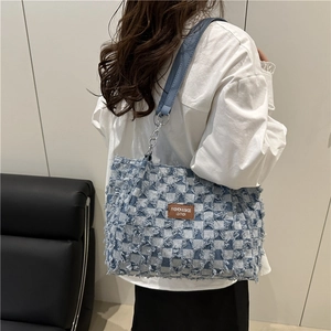 Blue checkerboard denim tote bag with frayed texture and silver chain strap details