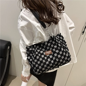 Fashionable black and white checkered tweed tote bag with leather strap and chain