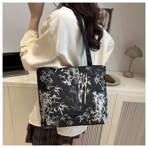 Detailed close-up of a quilted nylon tote bag with white bamboo print for daily commute