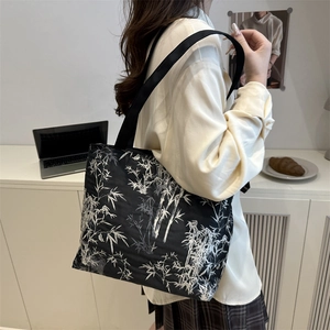 Women's black canvas tote bag with white bamboo print and large capacity for casual use