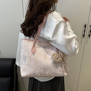 Pink jacquard tote bag with geometric E patterns and plush bear charm for daily commute