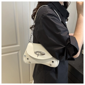 Close-up of cream white baguette bag with silver abstract buckle and metal rivets
