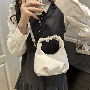 Chic creamy white crescent bag with pleated cloud handle and premium faux leather texture