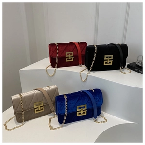 Detail of four velvet crossbody bags in burgundy black champagne and blue with chain straps