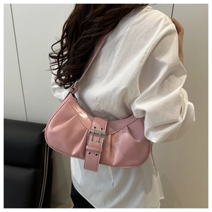 Detail of pink crescent underarm bag with decorative belt buckle and silver eyelets