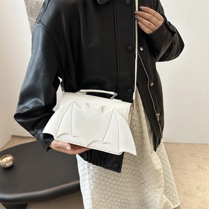 White bat-winged crossbody bag for women featuring unique gothic styling and top handle