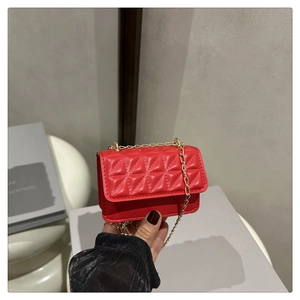 Detailed view of red quilted PU leather mini bag with elegant gold chain strap