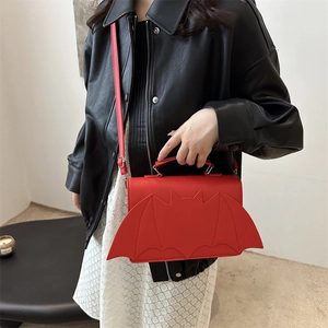 Red bat-wing designer crossbody handbag with top handle and adjustable strap