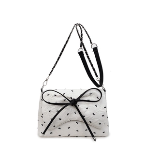 White jacquard crossbody bag with black butterfly patterns and large bow decoration