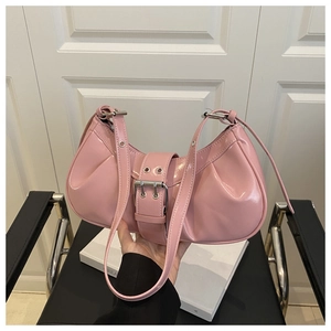 Detail of pink patent leather crescent bag with pleated texture and silver buckle decoration