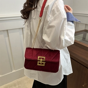 Quilted burgundy velvet shoulder bag with golden hardware and chain strap for women